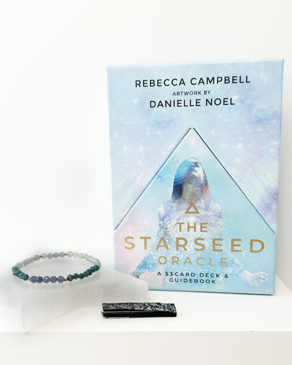 Starseed Oracle card set with bracelet and crystal on a white background