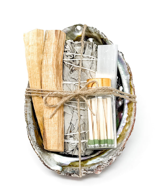 Set of matches wrapped in twine with a shell-like container on a white background