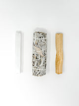 Three items on a white background: a cylindrical crystal bundle, a wooden stick, and a white tube.