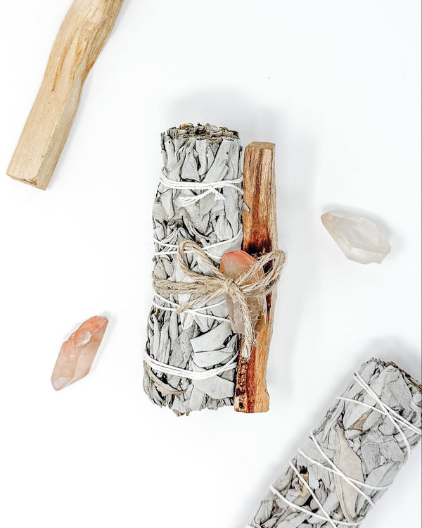 Sage smudge sticks with wooden handles on a white background