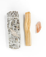 Sage bundle, Palo Santo stick, and Agate stone on a white background