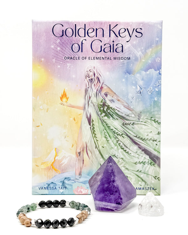 Set with 'Golden Keys of Gaia' Oracle cards, amethyst crystal, apophyllite crystal, l and return to Gaia bracelet on a white background